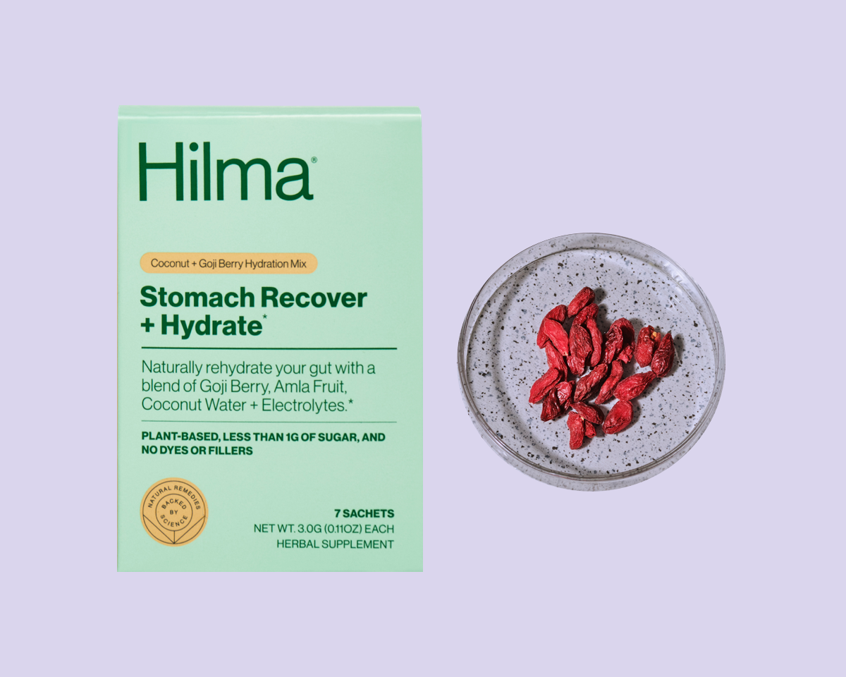 Stomach Recover + Hydrate box and goji berry in a petri dish on a purple background