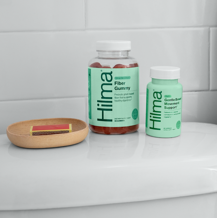 Hilma Fiber Gummy and Gentle Bowel Movement Support in bathroom on top of a toilet tank