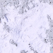 White powder (gluten-digesting enzymes) on a purple speckled background