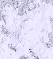 White powder (gluten-digesting enzymes) on a purple speckled background