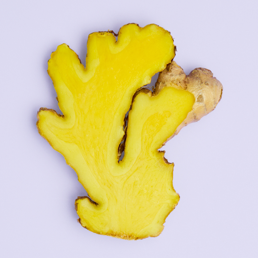 Slice of ginger on a purple background.