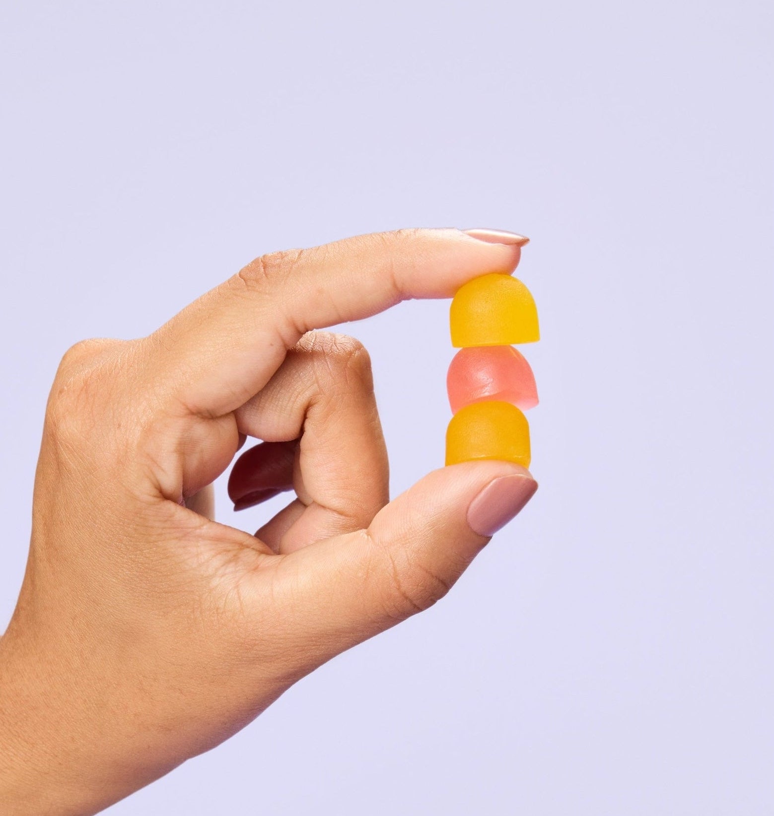 Hand holding stack of gummies 