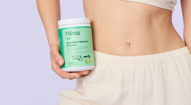 Person holding a container labeled 'Hima' against a light purple background