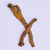 Two chicory root pieces on a purple background