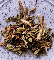 Dried dandelion root on a purple speckled background