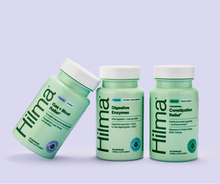 Three bottles of Hilma supplements on a light purple background